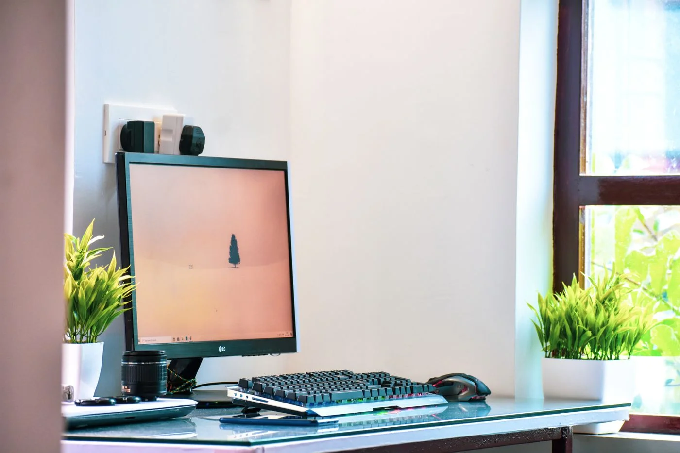 Small computer workspace beside a window