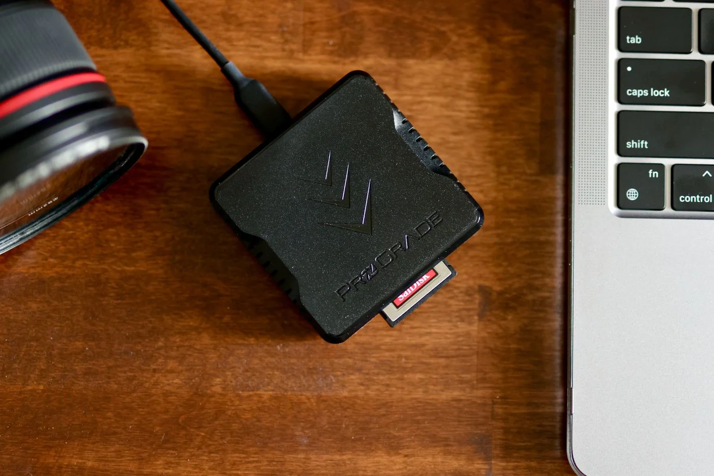 Card reader beside a camera and laptop