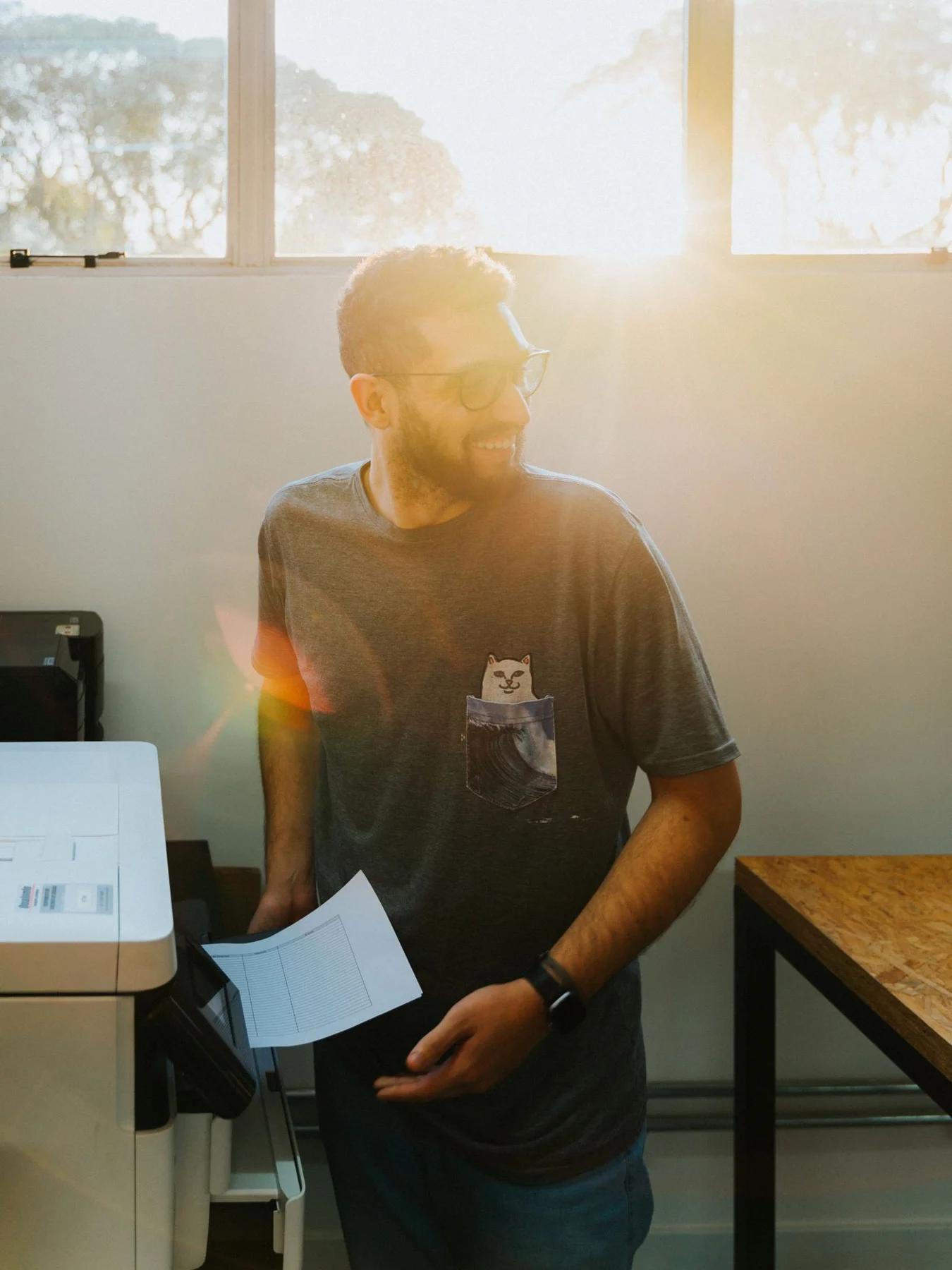 Person collecting paper from a printer