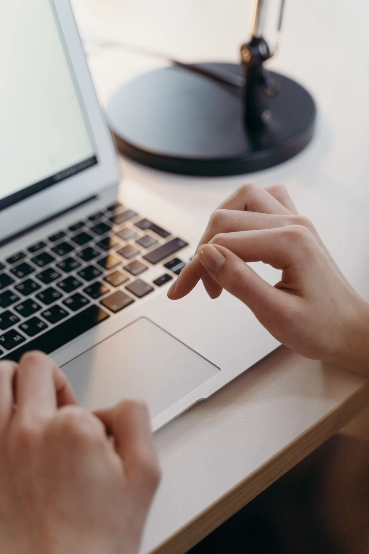 Hand using a laptop touchpad
