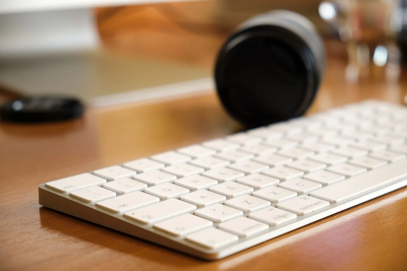 White keyboard on a wooden desk