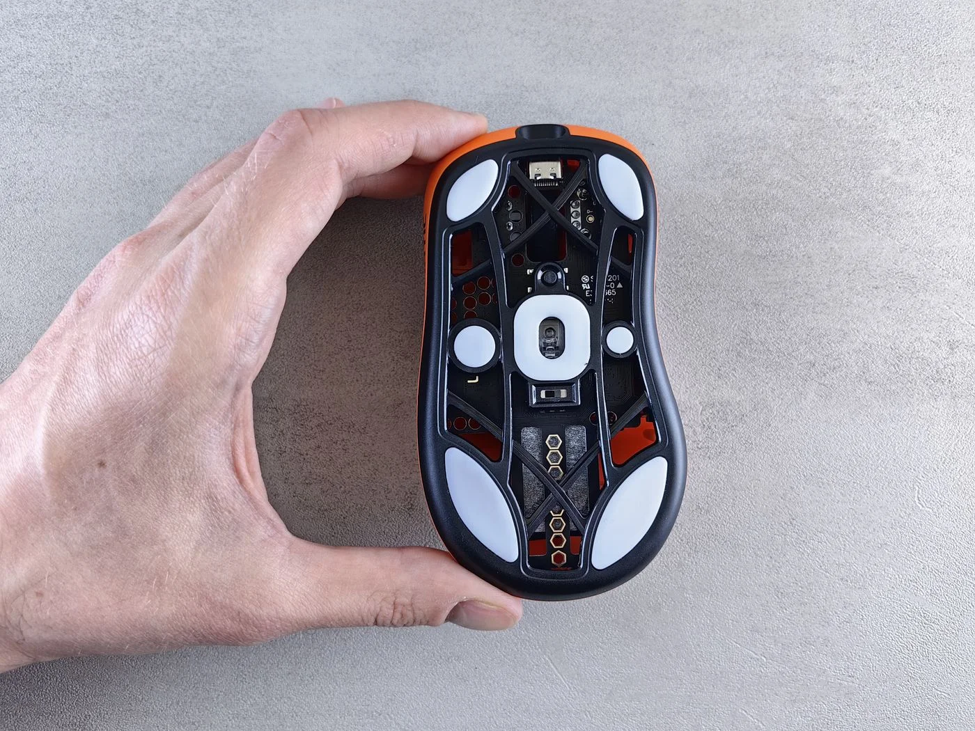 Underside of a computer mouse showing its sensor